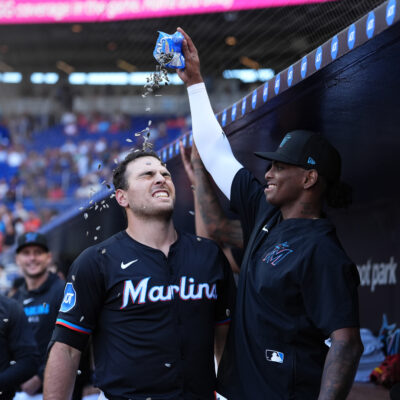 Matt Mervis of the Miami Marlins and Edward Cabrera #27 of the Miami Marlins celebrate in the game against the Washington Nationals at loanDepot park.
