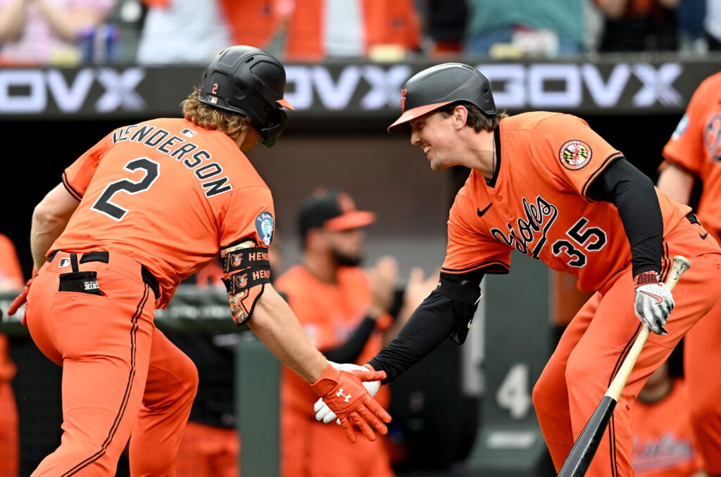 Gunnar Henderson of the Baltimore Orioles celebrates with Adley Rutschman after hitting a home run against the Cincinnati Reds at Oriole Park at Camden Yards.