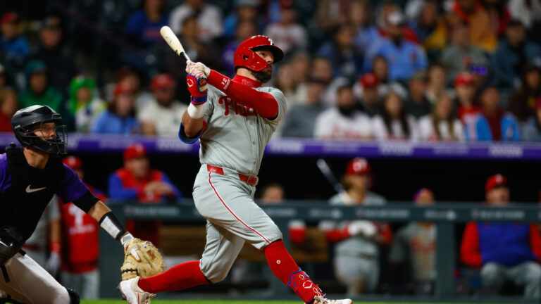 DENVER, CO - MAY 19: Kyle Schwarber #12 of the Philadelphia Phillies follows through on a solo home run in the ninth inning against the Colorado Rockies at Coors Field on May 19, 2025 in Denver, Colorado. The home run is Schwarber's 300th of his career. (Photo by Justin Edmonds/Getty Images)