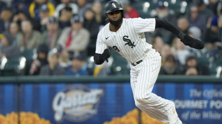 Luis Robert Jr of the Chicago White Sox steals second base in a game against the Milwaukee Brewers at Rate Field.
