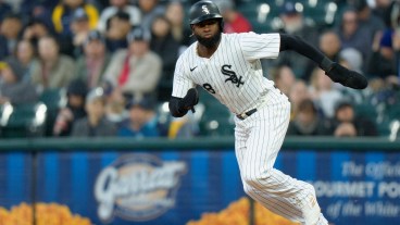 Luis Robert Jr of the Chicago White Sox steals second base in a game against the Milwaukee Brewers at Rate Field.
