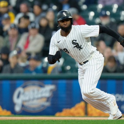Luis Robert Jr of the Chicago White Sox steals second base in a game against the Milwaukee Brewers at Rate Field.