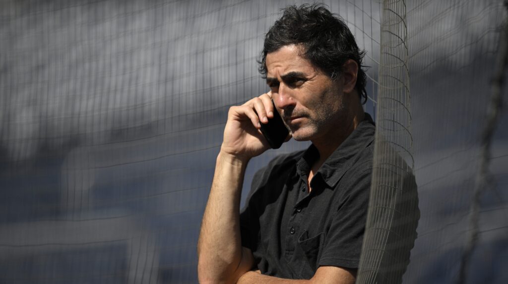 SAN DIEGO, CALIFORNIA - JUNE 23: General manager A. J. Preller of the San Diego Padres talks on the phone before the game against the Washington Nationals at Petco Park on June 23, 2025 in San Diego, California. (Photo by Orlando Ramirez/Getty Images)