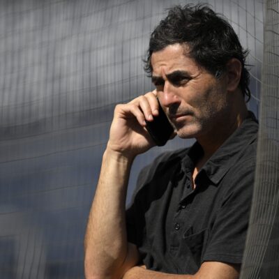 SAN DIEGO, CALIFORNIA - JUNE 23: General manager A. J. Preller of the San Diego Padres talks on the phone before the game against the Washington Nationals at Petco Park on June 23, 2025 in San Diego, California. (Photo by Orlando Ramirez/Getty Images)