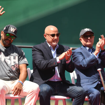 WASHINGTON, DC - JUNE 18: (L-R) Manger Dave Martinez #4, General Manager Mike Rizzo, and Principle Owner Mark Lerner of the Washington Nationals cheer during Ryan Zimmerman retirement ceremony before a baseball game against the Philadelphia Phillies at Nationals Park in Washington, DC. (Photo by Mitchell Layton/Getty Images)