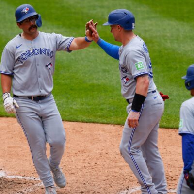 DENVER, CO - AUGUST 6: (L-R) Davis Schneider #36 of the Toronto Blue Jays is congratulated by Tyler Heineman #55 and Myles Straw #3 after hitting a three-run home run in the ninth inning against the Colorado Rockies at Coors Field on August 6, 2025 in Denver, Colorado. (Photo by Justin Edmonds/Getty Images)