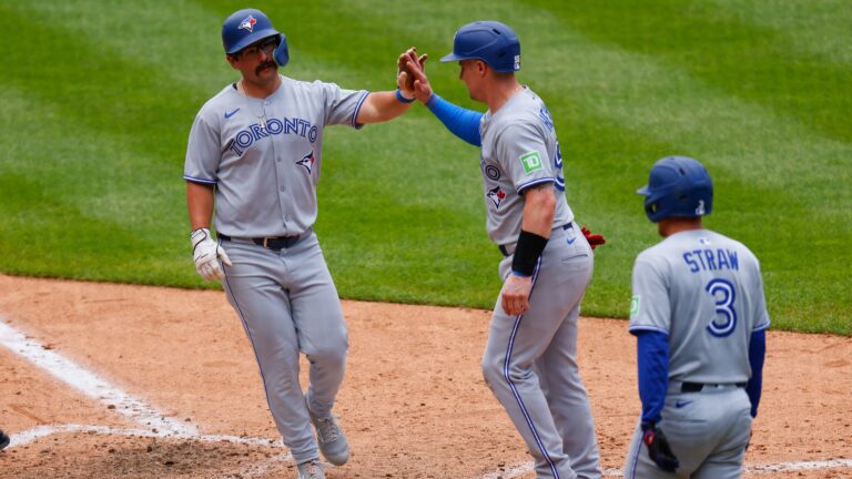 DENVER, CO - AUGUST 6: (L-R) Davis Schneider #36 of the Toronto Blue Jays is congratulated by Tyler Heineman #55 and Myles Straw #3 after hitting a three-run home run in the ninth inning against the Colorado Rockies at Coors Field on August 6, 2025 in Denver, Colorado. (Photo by Justin Edmonds/Getty Images)