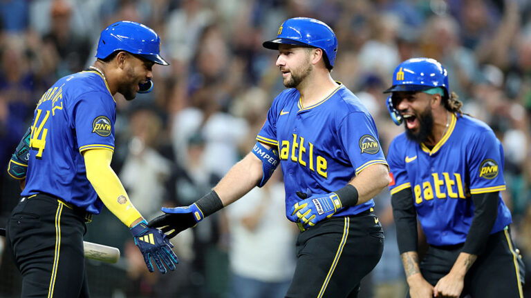 SEATTLE, WASHINGTON - AUGUST 08: Cal Raleigh #29 of the Seattle Mariners celebrates his three run home run with Julio Rodríguez #44 J.P. Crawford #3 during the eighth inning against the Tampa Bay Rays at T-Mobile Park on August 08, 2025 in Seattle, Washington. (Photo by Steph Chambers/Getty Images)