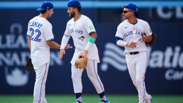 TORONTO, ON - AUGUST 14: Ernie Clement #22, Bo Bichette #11, and Andres Gimenez #0 of the Toronto Blue Jays celebrate defeating the Chicago Cubs in their MLB game at Rogers Centre on August 14, 2025 in Toronto, Ontario, Canada. (Photo by Mark Blinch/Getty Images)