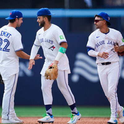 TORONTO, ON - AUGUST 14: Ernie Clement #22, Bo Bichette #11, and Andres Gimenez #0 of the Toronto Blue Jays celebrate defeating the Chicago Cubs in their MLB game at Rogers Centre on August 14, 2025 in Toronto, Ontario, Canada. (Photo by Mark Blinch/Getty Images)