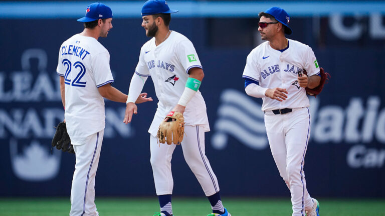 TORONTO, ON - AUGUST 14: Ernie Clement #22, Bo Bichette #11, and Andres Gimenez #0 of the Toronto Blue Jays celebrate defeating the Chicago Cubs in their MLB game at Rogers Centre on August 14, 2025 in Toronto, Ontario, Canada. (Photo by Mark Blinch/Getty Images)