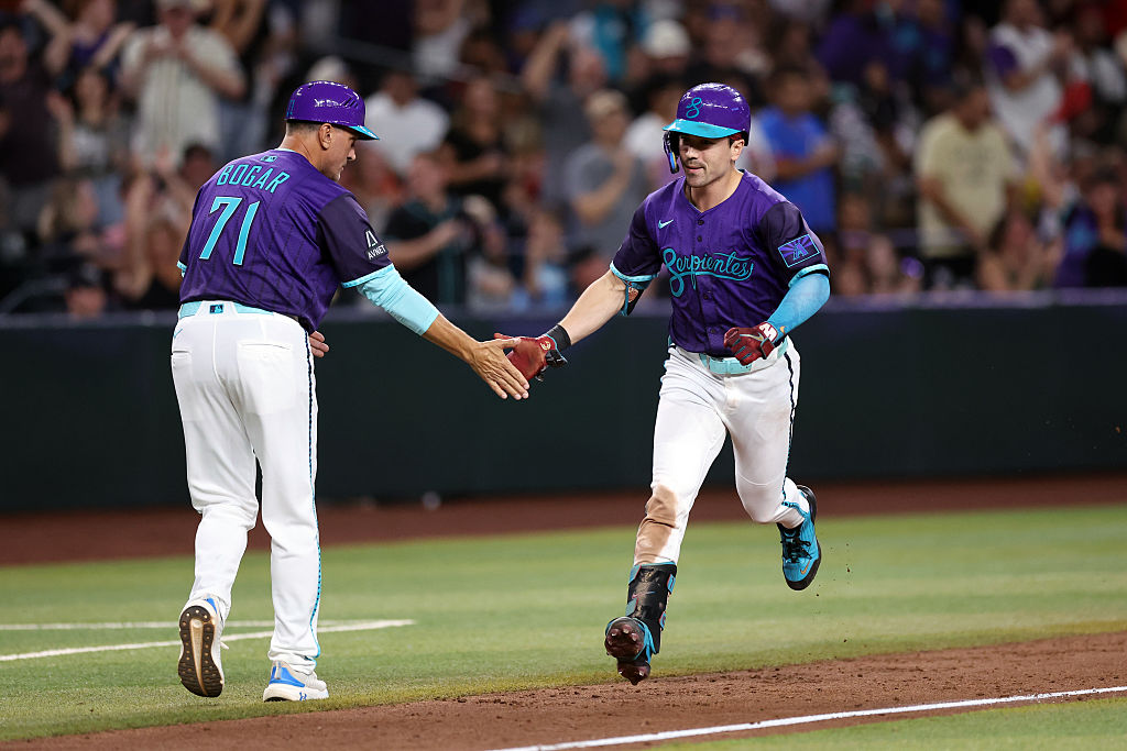 PHOENIX, ARIZONA - SEPTEMBER 05: Corbin Carroll #7 high fives third base coach Tim Bogar #71 of the Arizona Diamondbacks after hitting a three run home run against the Boston Red Sox during the eighth inning at Chase Field on September 05, 2025 in Phoenix, Arizona. The Diamondbacks defeated the Red Sox 10-5. (Photo by Chris Coduto/Getty Images)