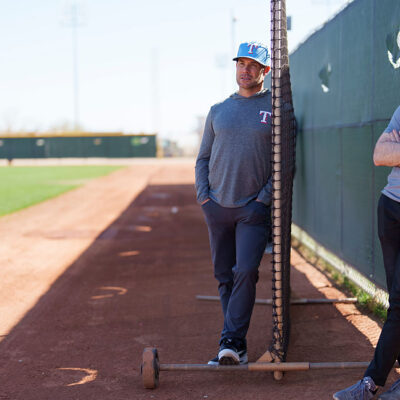 SURPRISE, AZ - FEBRUARY 21: Skip Schumaker, Senior Advisor of Baseball Operations, looks on with Mike Parnell, Senior Director of Professional Scouting, during a spring training workout at Surprise Stadium on February 21, 2025 in Surprise, Arizona. (Photo by Bailey Orr/Texas Rangers/Getty Images)