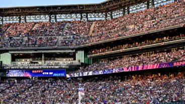 DENVER, COLORADO - JULY 4: Electronic signage wishes spectators a happy Fourth of July holiday in a general view as Tyler Kinley #40 of the Colorado Rockies warms up before pitching in the eighth inning against the Chicago White Sox at Coors Field on July 4, 2025 in Denver, Colorado. (Photo by Dustin Bradford/Getty Images)