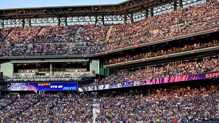 DENVER, COLORADO - JULY 4: Electronic signage wishes spectators a happy Fourth of July holiday in a general view as Tyler Kinley #40 of the Colorado Rockies warms up before pitching in the eighth inning against the Chicago White Sox at Coors Field on July 4, 2025 in Denver, Colorado. (Photo by Dustin Bradford/Getty Images)