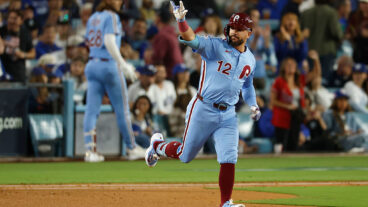 LOS ANGELES, CALIFORNIA - OCTOBER 08: Kyle Schwarber #12 of the Philadelphia Phillies reacts after hitting a solo home run against the Los Angeles Dodgers during the fourth inning in game three of the National League Division Series at Dodger Stadium on October 08, 2025 in Los Angeles, California. (Photo by Harry How/Getty Images)