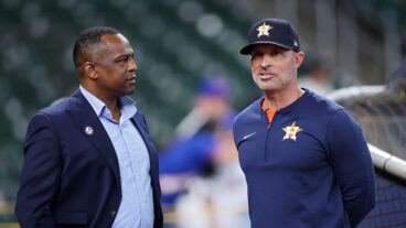 HOUSTON, TEXAS - MARCH 27: General Manager Dana Brown (L) and manager Joe Espada speak before the game against the New York Mets on Opening Day at Daikin Park on March 27, 2025 in Houston, Texas. (Photo by Tim Warner/Getty Images)