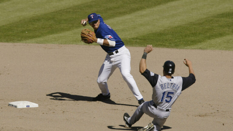 ARLINGTON-JUNE 2: Carlos Beltran #15 of the Kansas City Royals slides into third base as Alex Rodriguez #3 of the Texas Rangers throws to second base during the game against the Texas Rangers at The Ballpark in Arlington, Texas on June 2, 2002. The Rangers won 8-6. (Photo by Ronald Martinez/Getty Images)