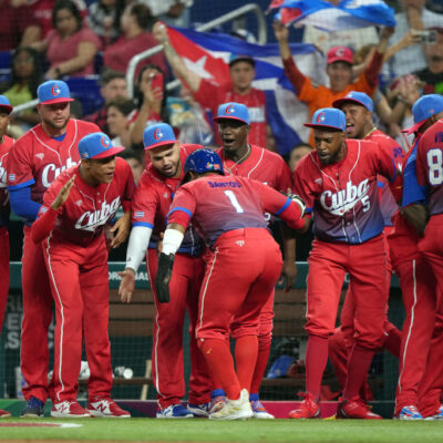 MIAMI, FLORIDA - MARCH 19: Roel Santos #1 of Team Cuba celebrates with teammates after scoring in the first inning against Team USA during the World Baseball Classic Semifinals at loanDepot park on March 19, 2023 in Miami, Florida. (Photo by Eric Espada/Getty Images)