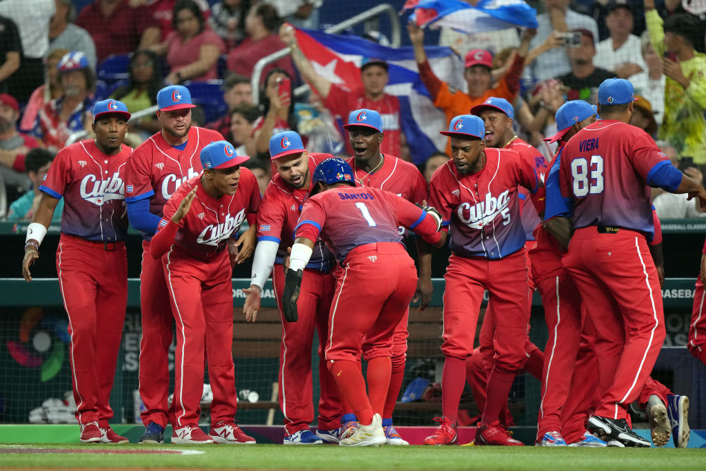 MIAMI, FLORIDA - MARCH 19: Roel Santos #1 of Team Cuba celebrates with teammates after scoring in the first inning against Team USA during the World Baseball Classic Semifinals at loanDepot park on March 19, 2023 in Miami, Florida. (Photo by Eric Espada/Getty Images)
