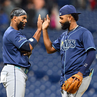 CLEVELAND, OHIO - AUGUST 25: Yandy Díaz #2 and Junior Caminero #13 of the Tampa Bay Rays celebrate after the Rays defeated the Cleveland Guardians at Progressive Field on August 25, 2025 in Cleveland, Ohio. The Rays defeated the Guardians 9-0. (Photo by Jason Miller/Getty Images)