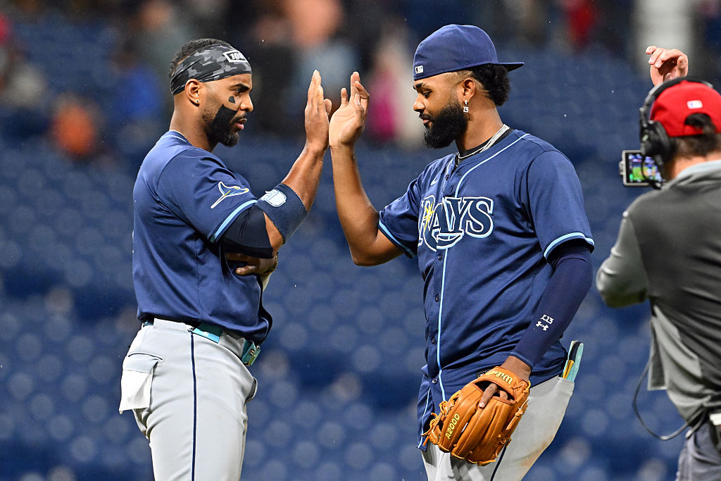 CLEVELAND, OHIO - AUGUST 25: Yandy Díaz #2 and Junior Caminero #13 of the Tampa Bay Rays celebrate after the Rays defeated the Cleveland Guardians at Progressive Field on August 25, 2025 in Cleveland, Ohio. The Rays defeated the Guardians 9-0. (Photo by Jason Miller/Getty Images)