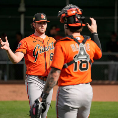 SCOTTSDALE, ARIZONA - FEBRUARY 11: Landen Roupp #65 and Eric Haase #18 of the San Francisco Giants shake hands during Spring Training at Scottsdale Stadium on February 11, 2026 in Scottsdale, Arizona. (Photo by Andy Kuno/San Francisco Giants/Getty Images)
