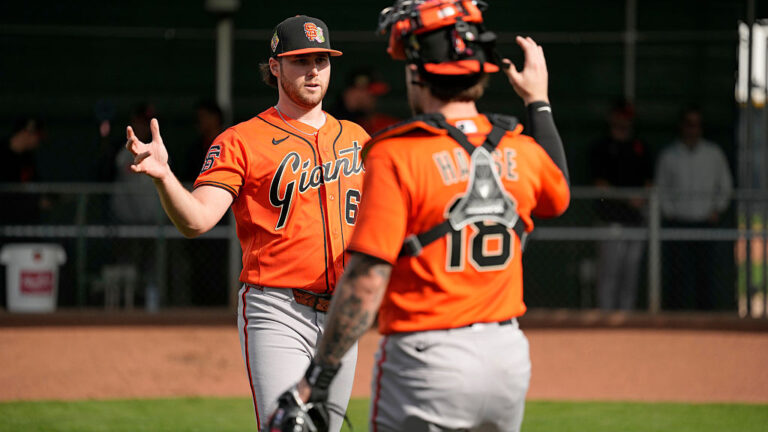 SCOTTSDALE, ARIZONA - FEBRUARY 11: Landen Roupp #65 and Eric Haase #18 of the San Francisco Giants shake hands during Spring Training at Scottsdale Stadium on February 11, 2026 in Scottsdale, Arizona. (Photo by Andy Kuno/San Francisco Giants/Getty Images)