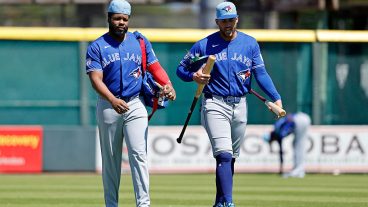 BRADENTON, FL - MARCH 21: Vladimir Guerrero Jr. (27) and George Springer (4) of the Toronto Blue Jays walk to the dugout before a spring training game against the Pittsburgh Pirates on March 21, 2026 at LECOM Park in Bradenton, Florida. (Photo by Joe Robbins/Icon Sportswire via Getty Images)