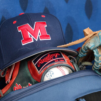 HOOVER, AL - MAY 23: A hat with the Ole Miss logo and glove sit in the dugout before the SEC Baseball Tournament Quarterfinals game between Mississippi Rebels and Arkansas Razorbacks on May 23, 2025, at Hoover Metropolitan Stadium in Hoover, Alabama. (Photo by David Buono/Icon Sportswire via Getty Images)