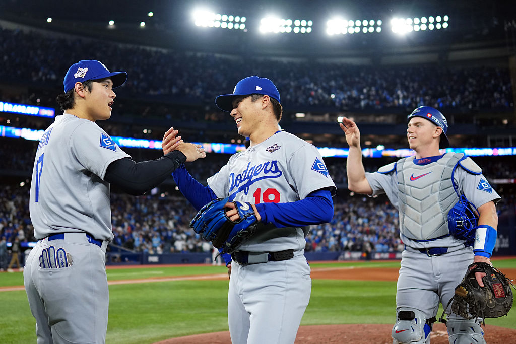 TORONTO, ON - OCTOBER 25: Shohei Ohtani #17 and Yoshinobu Yamamoto #18 of the Los Angeles Dodgers celebrate after the Dodgers defeated the Toronto Blue Jay in Game Two of the 2025 World Series presented by Capital One at Rogers Centre on Saturday, October 25, 2025 in Toronto, Ontario, Canada. (Photo by Daniel Shirey/MLB Photos via Getty Images)