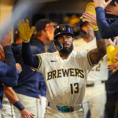 MILWAUKEE, WI - MARCH 23: Luis Rengifo #13 pf the Milwaukee Brewers celebrates with teammates in the dugout after scoring in the second inning during the game between the Cincinnati Reds and the Milwaukee Brewers at American Family Field on Monday, March 23, 2026 in Milwaukee, Wisconsin. (Photo by Kylie Bridenhagen/MLB Photos via Getty Images)