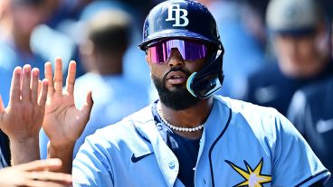 NORTH PORT, FLORIDA - MARCH 24: Junior Caminero #13 of the Tampa Bay Rays celebrates with teammates in the dugout after scoring in the second inning against the Atlanta Braves during a Grapefruit League spring training game at CoolToday Park on March 24, 2026 in North Port, Florida. (Photo by Julio Aguilar/Getty Images)