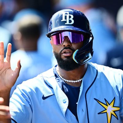 NORTH PORT, FLORIDA - MARCH 24: Junior Caminero #13 of the Tampa Bay Rays celebrates with teammates in the dugout after scoring in the second inning against the Atlanta Braves during a Grapefruit League spring training game at CoolToday Park on March 24, 2026 in North Port, Florida. (Photo by Julio Aguilar/Getty Images)