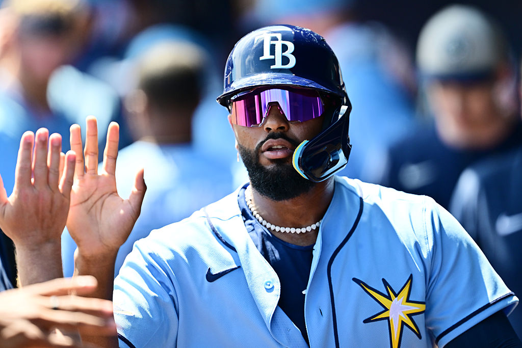 NORTH PORT, FLORIDA - MARCH 24: Junior Caminero #13 of the Tampa Bay Rays celebrates with teammates in the dugout after scoring in the second inning against the Atlanta Braves during a Grapefruit League spring training game at CoolToday Park on March 24, 2026 in North Port, Florida. (Photo by Julio Aguilar/Getty Images)