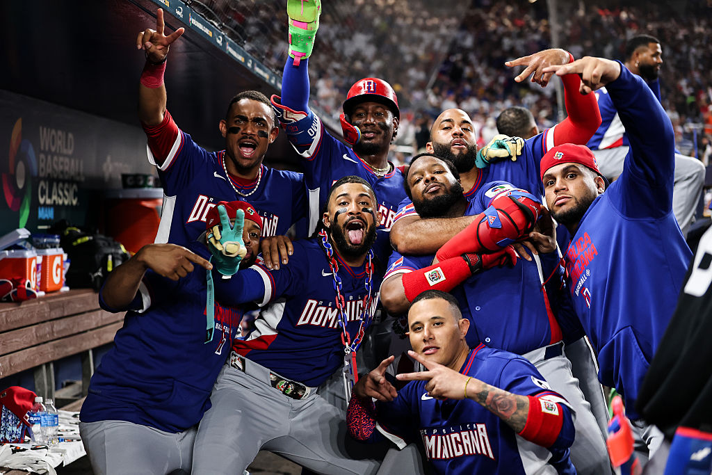 MIAMI, FLORIDA - MARCH 11: Fernando Tatis Jr. of the Dominican Republic celebrates with teammates Vladimir Guerrero Jr. #27Geraldo Perdomo #2,  Manny MacHado #3 , and Julio Rodríguez #44 after hitting  a home run during the fourth inning against  Venezuela at loanDepot park on March 11, 2026 in Miami, Florida. (Photo by Carmen Mandato/Getty Images)