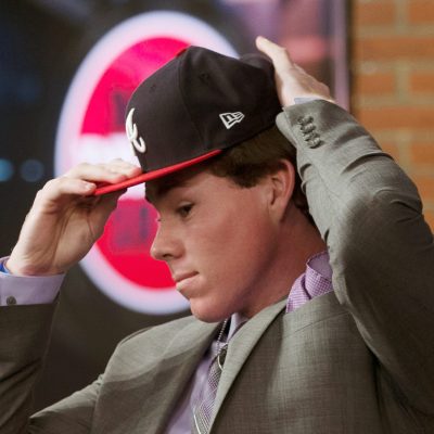 SECAUCUS, NJ - JUNE 4: Carter Stewart puts on an Atlanta Braves cap after being selected eighth overall by the Braves during the 2018 Major League Baseball Draft at Studio 42 at the MLB Network on Monday, June 4, 2018 in Secaucus, New Jersey. (Photo by Mary DeCicco/MLB via Getty Images)
