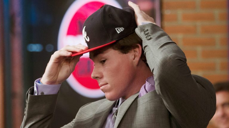 SECAUCUS, NJ - JUNE 4: Carter Stewart puts on an Atlanta Braves cap after being selected eighth overall by the Braves during the 2018 Major League Baseball Draft at Studio 42 at the MLB Network on Monday, June 4, 2018 in Secaucus, New Jersey. (Photo by Mary DeCicco/MLB via Getty Images)