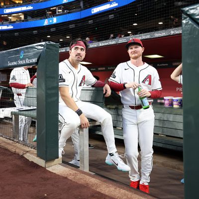 PHOENIX, ARIZONA - MARCH 30: Corbin Carroll #7 (L) and Pavin Smith #26 of the Arizona Diamondbacks look on from the dugout before the home opener against the Detroit Tigers at Chase Field on March 30, 2026 in Phoenix, Arizona. The Diamondbacks defeated the Tigers 9-6. (Photo by Chris Coduto/Getty Images)