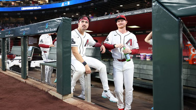 PHOENIX, ARIZONA - MARCH 30: Corbin Carroll #7 (L) and Pavin Smith #26 of the Arizona Diamondbacks look on from the dugout before the home opener against the Detroit Tigers at Chase Field on March 30, 2026 in Phoenix, Arizona. The Diamondbacks defeated the Tigers 9-6. (Photo by Chris Coduto/Getty Images)