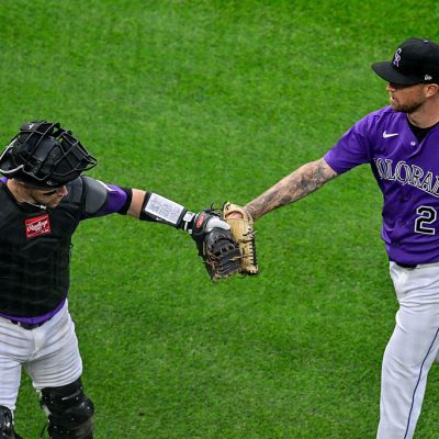 DENVER, CO - APRIL 7: Colorado Rockies pitcher Kyle Freeland (21) and catcher Brett Sullivan (26) celebrate after an ABS challenge resulted in an overturned ball call and strikeout to end the first inning against the Houston Astros during a game between the Houston Astros and the Colorado Rockies at Coors Field on April 7, 2026 in Denver, Colorado. (Photo by Dustin Bradford/Icon Sportswire via Getty Images)