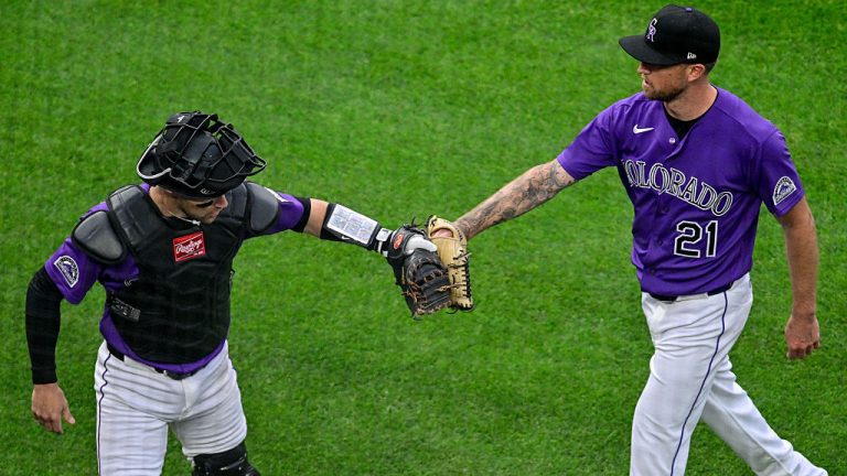 DENVER, CO - APRIL 7: Colorado Rockies pitcher Kyle Freeland (21) and catcher Brett Sullivan (26) celebrate after an ABS challenge resulted in an overturned ball call and strikeout to end the first inning against the Houston Astros during a game between the Houston Astros and the Colorado Rockies at Coors Field on April 7, 2026 in Denver, Colorado. (Photo by Dustin Bradford/Icon Sportswire via Getty Images)