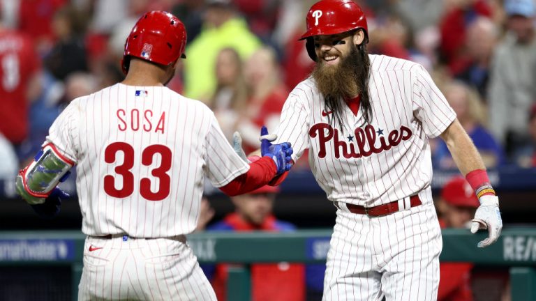 PHILADELPHIA, PENNSYLVANIA - SEPTEMBER 27: Edmundo Sosa #33 and Brandon Marsh #16 of the Philadelphia Phillies react following a solo home run hit by Sosa during the fifth inning against the Pittsburgh Pirates at Citizens Bank Park on September 27, 2023 in Philadelphia, Pennsylvania. (Photo by Tim Nwachukwu/Getty Images)