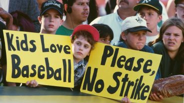 General view of young baseball fans holding up signs protesting against the proposed strike by the Major League Baseball Players Association during the Major League Baseball American League West game between the Oakland Athletics and the Seattle Mariners on 11th August 1994 at the Oakland-Alameda County Coliseum in Oakland, California, United States. The strike began on 12th August 1994, and resulted in the remainder of that season being canceled, including the postseason and, for the first time since 1904, the World Series. The strike was suspended on 2nd April 1995, after 232 days, making it the longest such stoppage in MLB history. (Photo by Otto Greule Jr/Allsport/Getty Images)