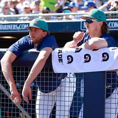 PEORIA, ARIZONA - MARCH 11: Logan Gilbert (L) #36 and Bryce Miller #50 of the Seattle Mariners look on from the dugout during a Spring Training game against the Colorado Rockies at Peoria Stadium on March 11, 2026 in Peoria, Arizona. (Photo by Brandon Sloter/Getty Images)