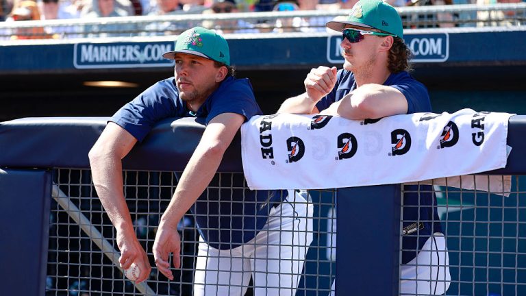 PEORIA, ARIZONA - MARCH 11: Logan Gilbert (L) #36 and Bryce Miller #50 of the Seattle Mariners look on from the dugout during a Spring Training game against the Colorado Rockies at Peoria Stadium on March 11, 2026 in Peoria, Arizona. (Photo by Brandon Sloter/Getty Images)