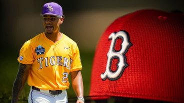 OMAHA, NEBRASKA - JUNE 22: Anthony Eyanson #24 of the LSU Tigers walks off the field in Game 2 of the NCAA College World Series baseball finals against the Coastal Carolina Chanticleers at Charles Schwab Field on June 22, 2025 in Omaha, Nebraska. (Photo by Jay Biggerstaff/Getty Images) / FT. MYERS, FLORIDA - FEBRUARY 15: A hat is displayed as the sun rises during a Boston Red Sox spring training team workout on February 15, 2024 at jetBlue Park at Fenway South in Fort Myers, Florida. (Photo by Billie Weiss/Boston Red Sox/Getty Images)