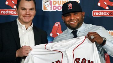 BOSTON - NOVEMBER 25: The Boston Red Sox introduced newly signed third baseman Pablo Sandoval, right, at a press conference at Fenway Park. Sandoval holding up his new jersey with general manager Ben Cherington, left. A World Series ring from his days with the San Francisco Giants is on his left hand. (Photo by Jim Davis/The Boston Globe via Getty Images)