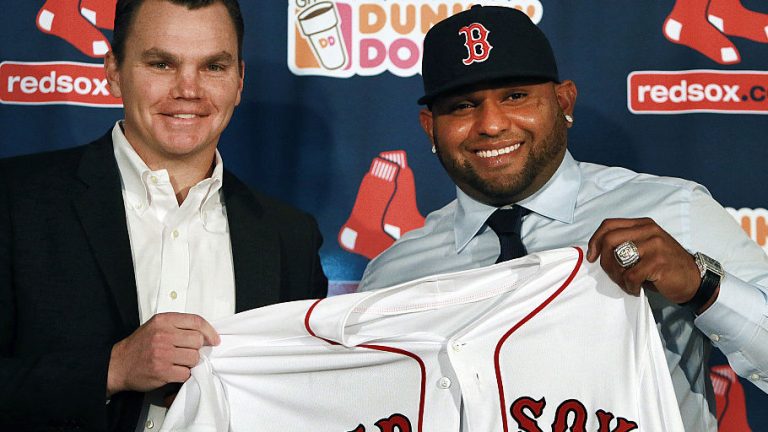 BOSTON - NOVEMBER 25: The Boston Red Sox introduced newly signed third baseman Pablo Sandoval, right, at a press conference at Fenway Park. Sandoval holding up his new jersey with general manager Ben Cherington, left. A World Series ring from his days with the San Francisco Giants is on his left hand. (Photo by Jim Davis/The Boston Globe via Getty Images)
