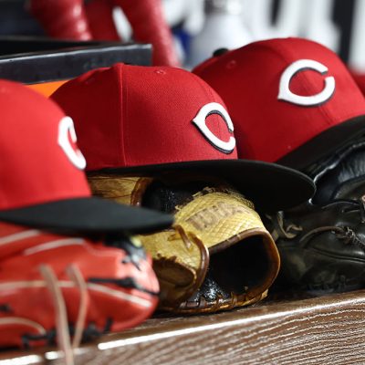 MIAMI, FL - APRIL 07: Cincinnati Reds caps and gloves rest in the dugout during the game between the Cincinnati Reds and the Miami Marlins on Tuesday. APril 7, 2026 at LoanDepot Park in Miami, FL (Photo by Peter Joneleit/Icon Sportswire via Getty Images)